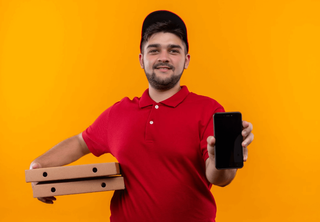 food delivery partner holding out mobile phone